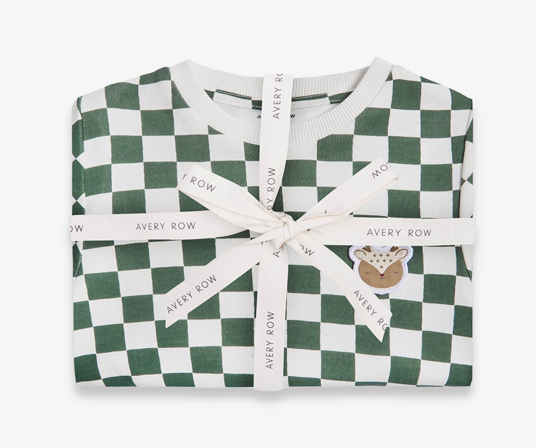 Folded green and white checkered garment with a ribbon, branded 'Avery Row', on a white background