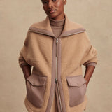 Model wearing Varley Eleanor Patch Pocket Fleece in soft borg fabric with DoubleSoft® trims and front zip.