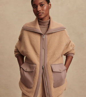 Model wearing Varley Eleanor Patch Pocket Fleece in soft borg fabric with DoubleSoft® trims and front zip.