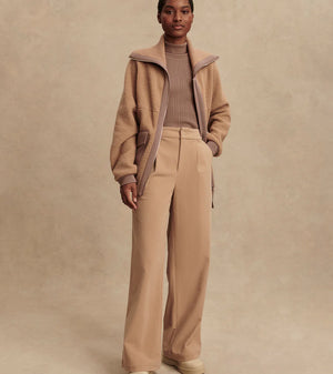 Model wearing Varley Eleanor Patch Pocket Fleece in soft borg fabric with DoubleSoft® trims and front zip.