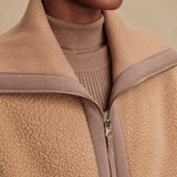 Model wearing Varley Eleanor Patch Pocket Fleece in soft borg fabric with DoubleSoft® trims and front zip.