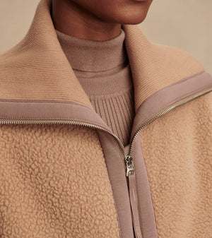 Model wearing Varley Eleanor Patch Pocket Fleece in soft borg fabric with DoubleSoft® trims and front zip.