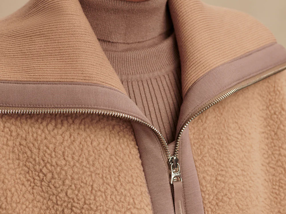 Model wearing Varley Eleanor Patch Pocket Fleece in soft borg fabric with DoubleSoft® trims and front zip.