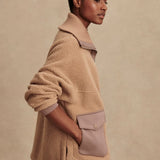 Model wearing Varley Eleanor Patch Pocket Fleece in soft borg fabric with DoubleSoft® trims and front zip.