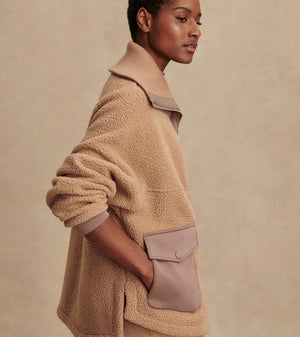 Model wearing Varley Eleanor Patch Pocket Fleece in soft borg fabric with DoubleSoft® trims and front zip.