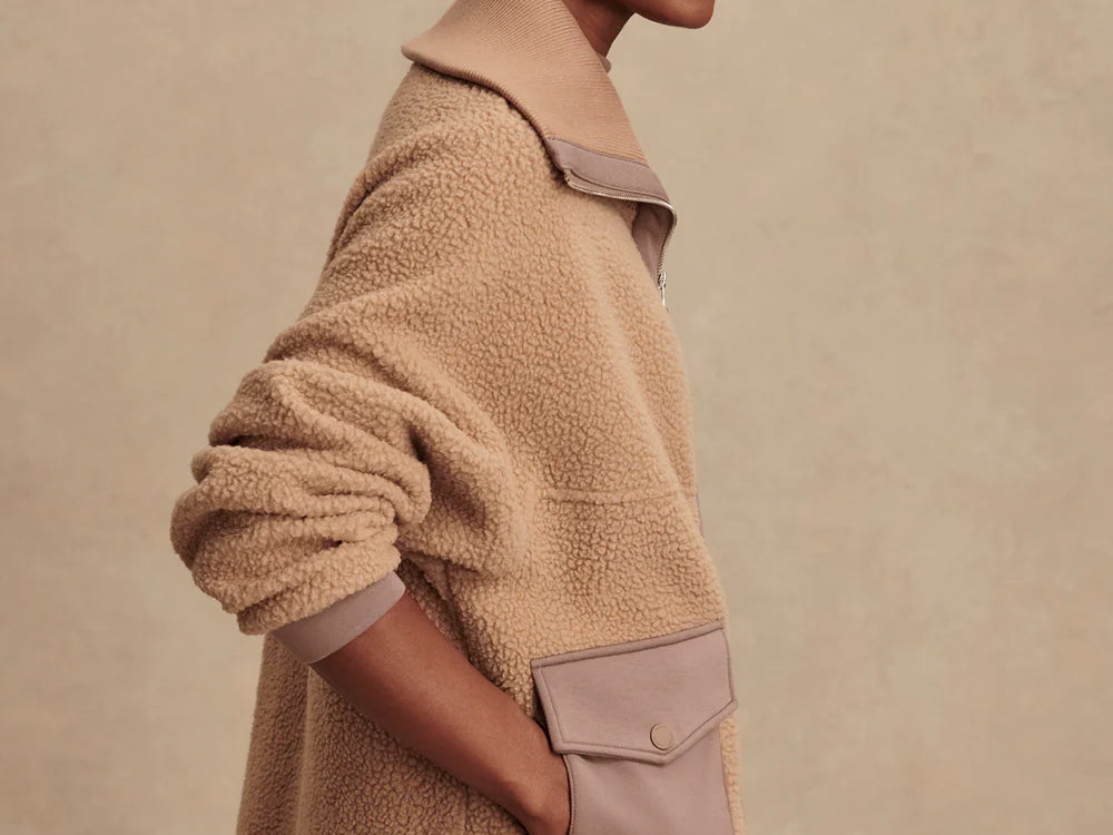 Model wearing Varley Eleanor Patch Pocket Fleece in soft borg fabric with DoubleSoft® trims and front zip.