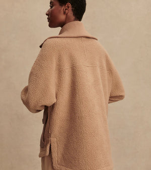 Model wearing Varley Eleanor Patch Pocket Fleece in soft borg fabric with DoubleSoft® trims and front zip.