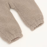ALF Eco Pramsuit in beige, close-up of the soft fleece texture and elasticated cuffs on the legs