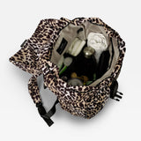 Elise Eco Changing Backpack Leopard, open from above showing nappies, bottle, muslin and other items inside