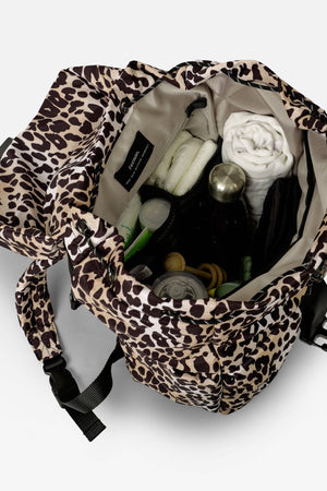 Elise Eco Changing Backpack Leopard, open from above showing nappies, bottle, muslin and other items inside