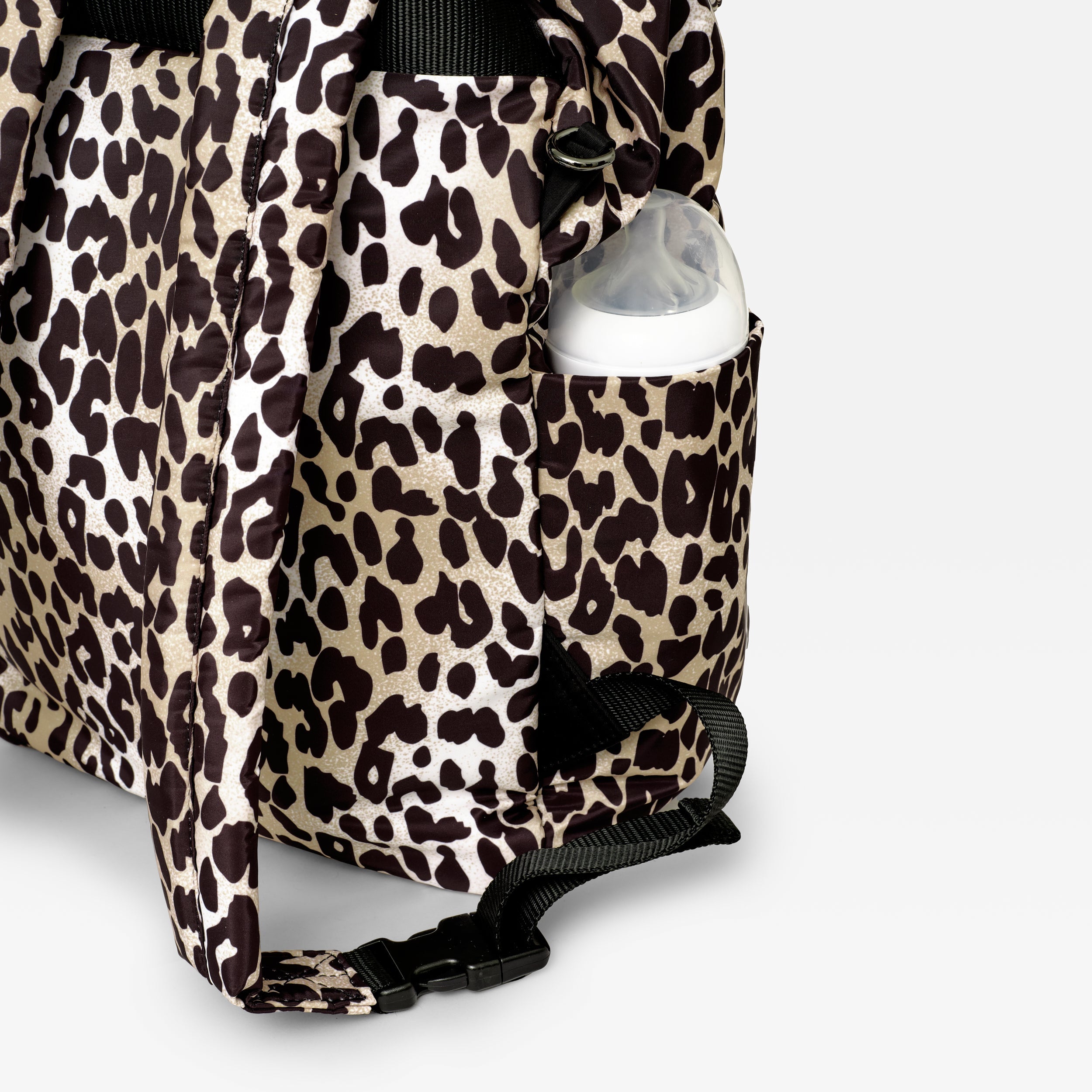 Elise Eco Changing Backpack Leopard, close-up of side pocket holding a baby bottle, with strap buckle below