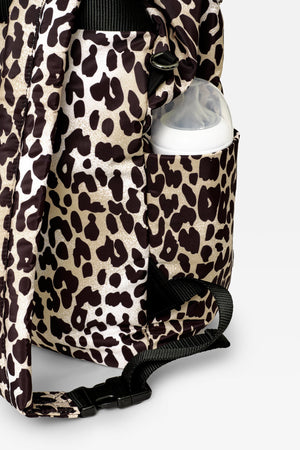 Elise Eco Changing Backpack Leopard, close-up of side pocket holding a baby bottle, with strap buckle below