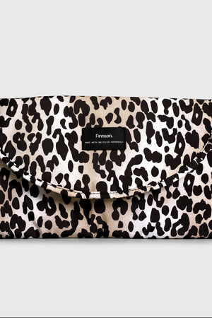 Oslo Eco Travel Changing Mat in Leopard, folded closed with a black Finnson label on the front flap