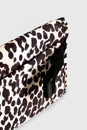 Oslo Eco Travel Changing Mat in Leopard, close-up of the black strap loop on the side of the folded mat