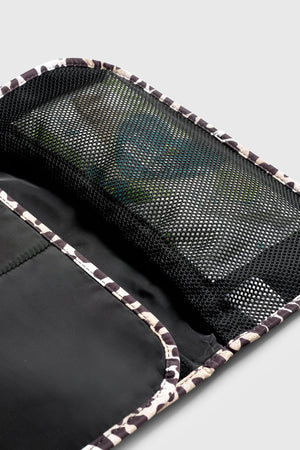 Oslo Eco Travel Changing Mat in Leopard, close-up of the open black mesh pocket with items inside