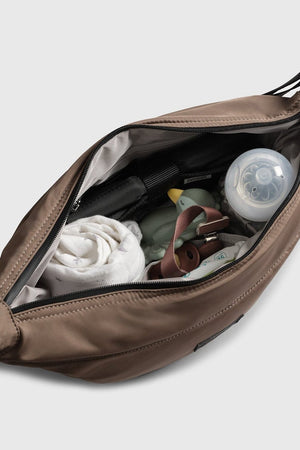 Open Osma stroller organiser in Mocha seen from above, holding a muslin, baby bottle, dummy and nappy