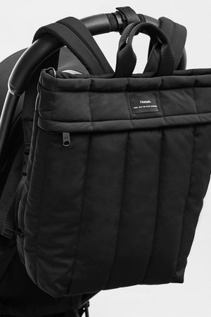 Black stroller bag attached to a stroller on a light gray background