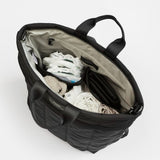 Black bag with clothes inside on a white background