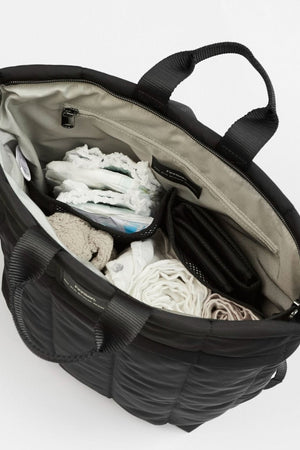 Black bag with clothes inside on a white background