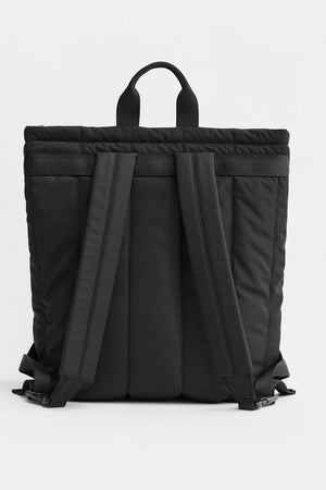 A black backpack shown from the back, featuring padded side pockets, a top carry handle, and wide shoulder straps, photographed against a clean white studio background.