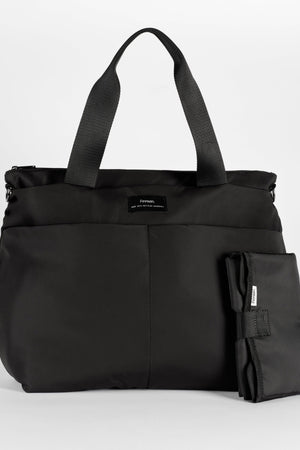 Sigrid Eco Changing Bag black, front view with two top handles and the folded changing mat beside it
