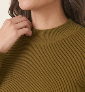 Rib Knit Peplum Khaki Jumper close-up of the ribbed knit and high funnel neckline on a smiling woman