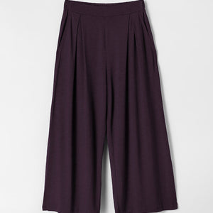 Dark purple wide-leg pants on a light gray background