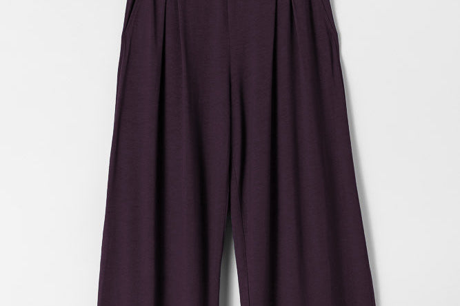 Dark purple wide-leg pants on a light gray background