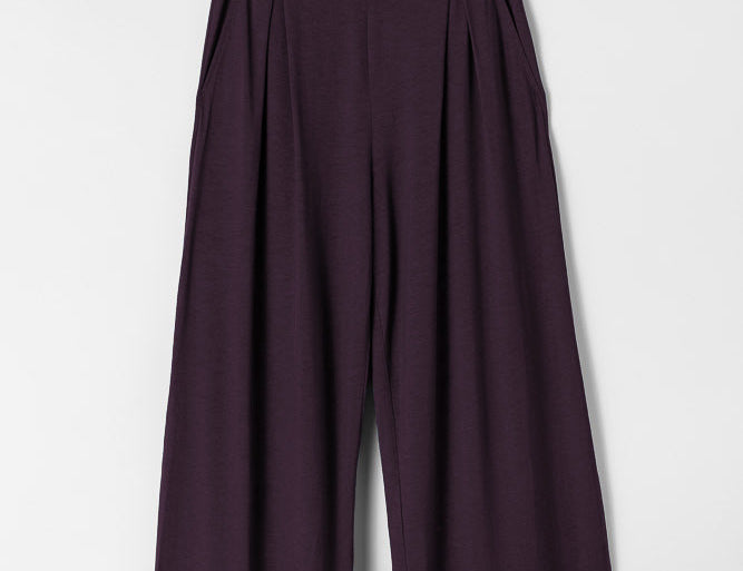 Dark purple wide-leg pants on a light gray background
