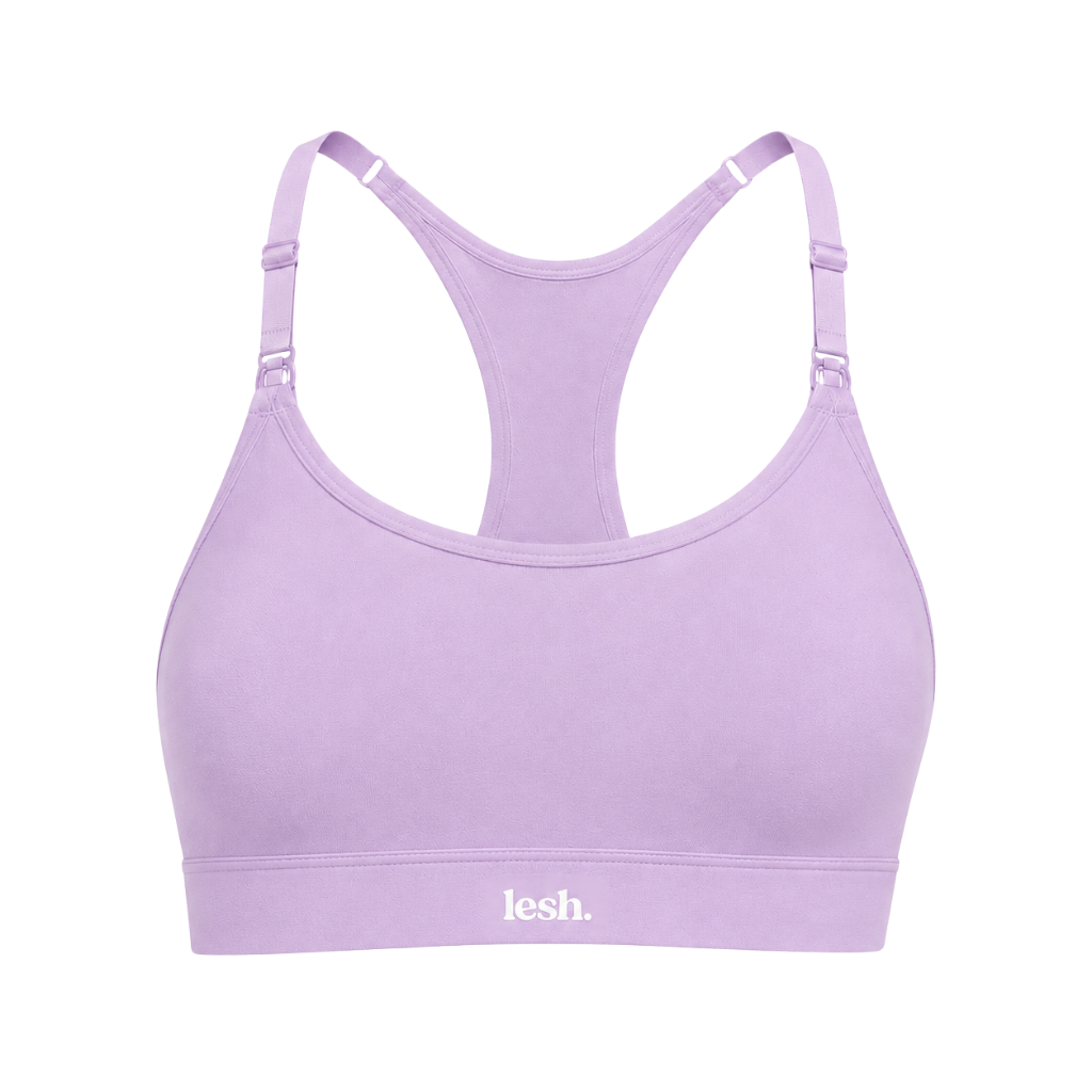 A light purple racerback sports bra with adjustable shoulder straps and a white 'lesh.' logo printed on the underband, shown against a plain white background.