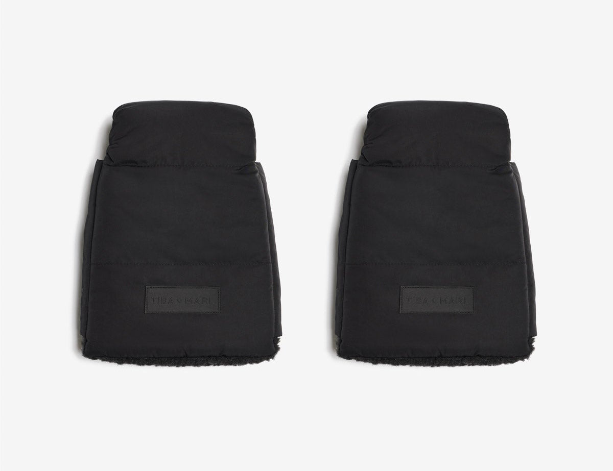 Two black car floor mats on a white background