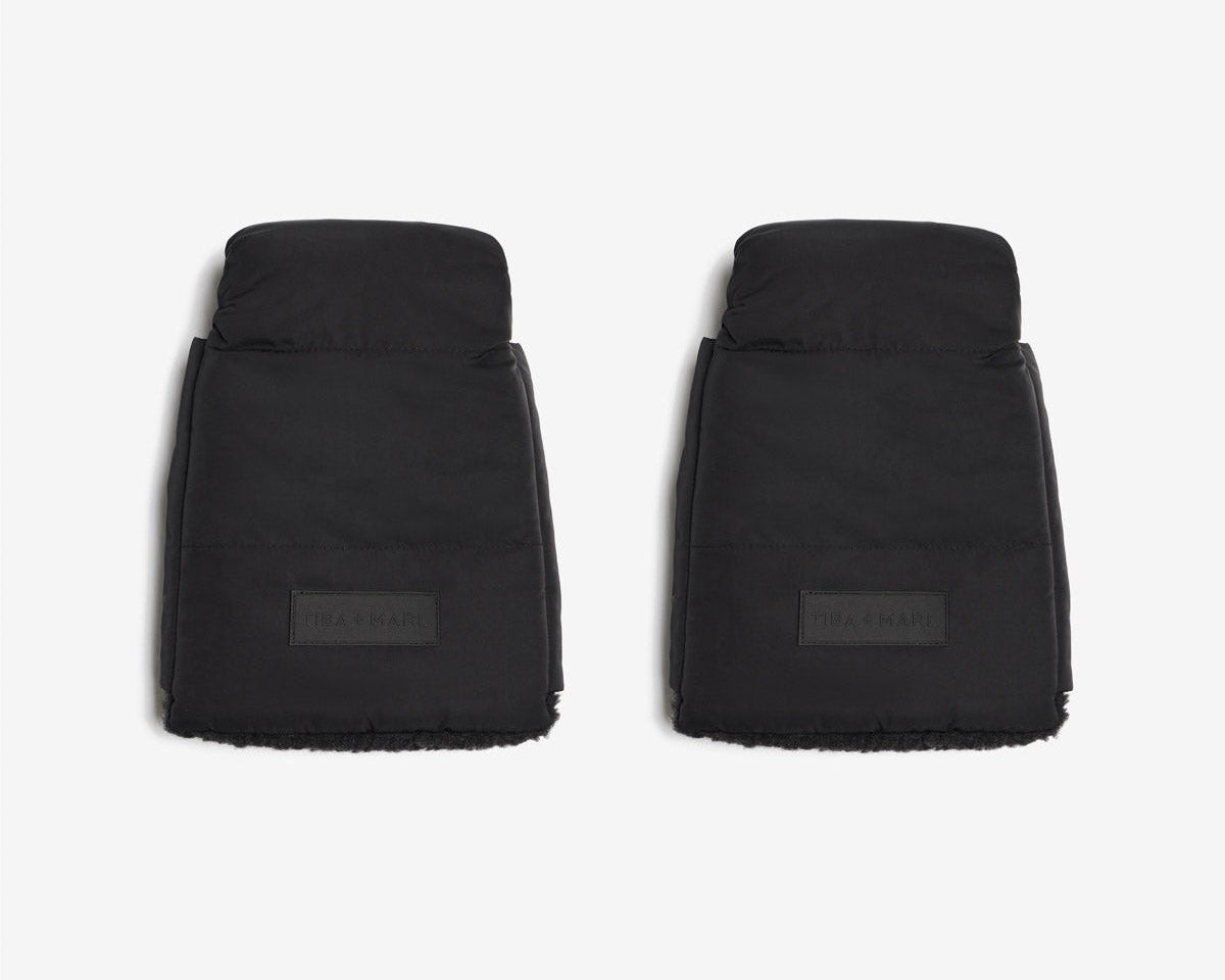 Two black car floor mats on a white background