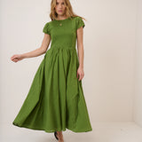 Woman wearing a green dress against a white background