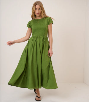 Woman wearing a green dress against a white background