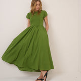Woman wearing a green dress against a white background