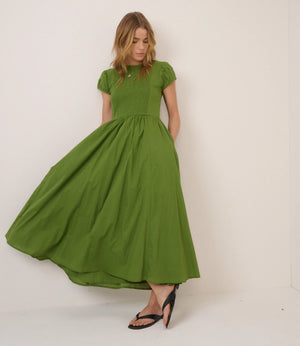 Woman wearing a green dress against a white background