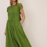 Woman wearing a green dress against a white background