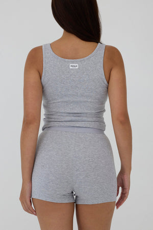 A woman shown from the back wearing a heather gray sleeveless tank top and matching high-waisted shorts against a plain light gray studio background.