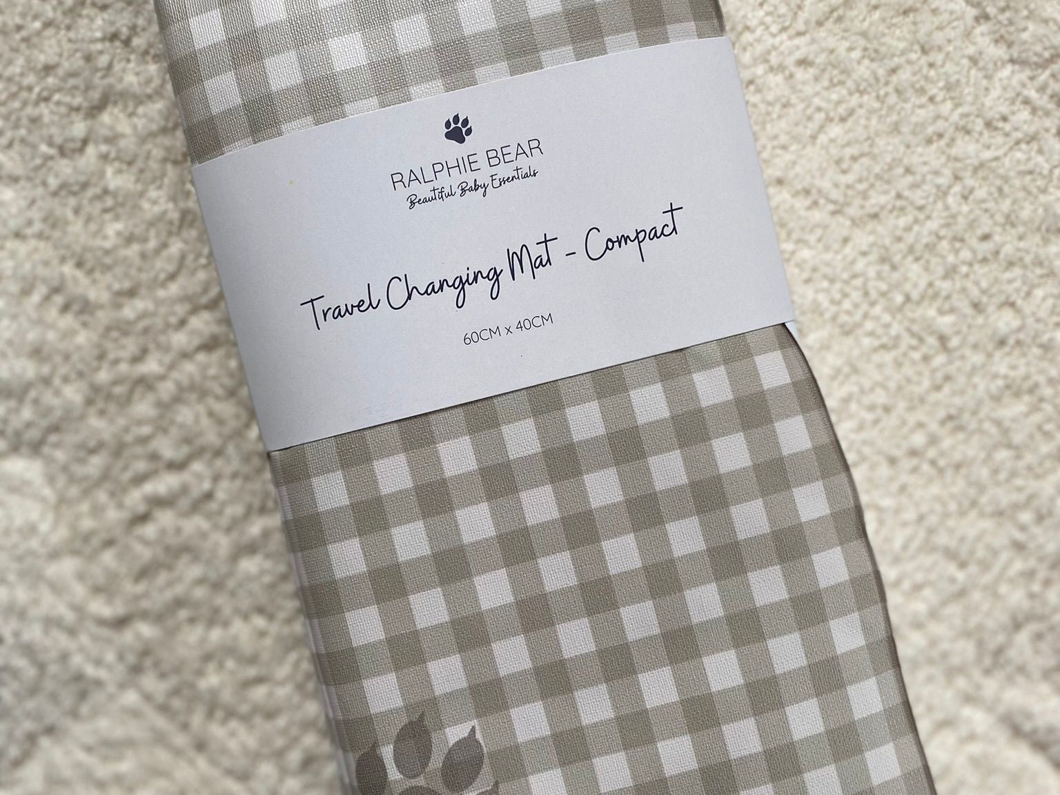 Folded checkered mat with a label on a textured surface