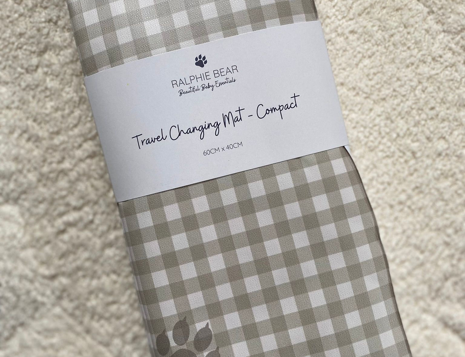 Folded checkered mat with a label on a textured surface