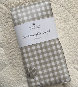 Folded checkered mat with a label on a textured surface
