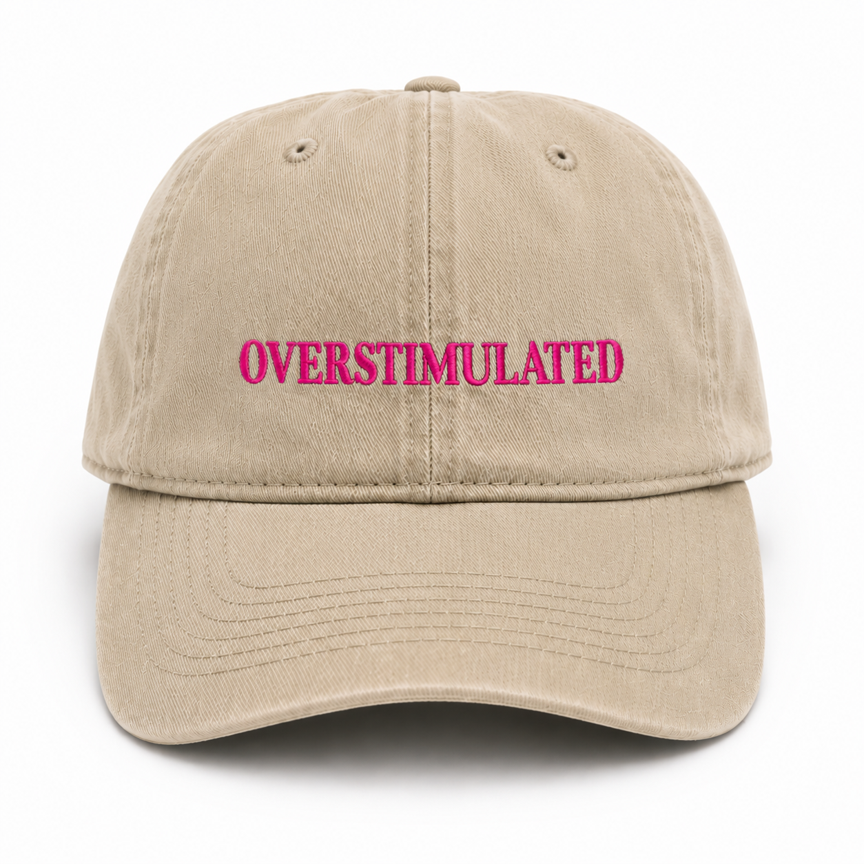 Beige cap with 'OVERSTIMULATED' in pink text on a white background