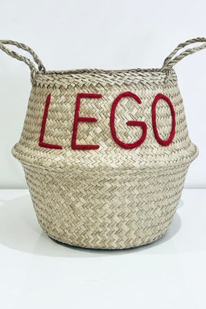 LEGO belly basket, large, front view of woven basket with red LEGO lettering and two looped handles on a white surface