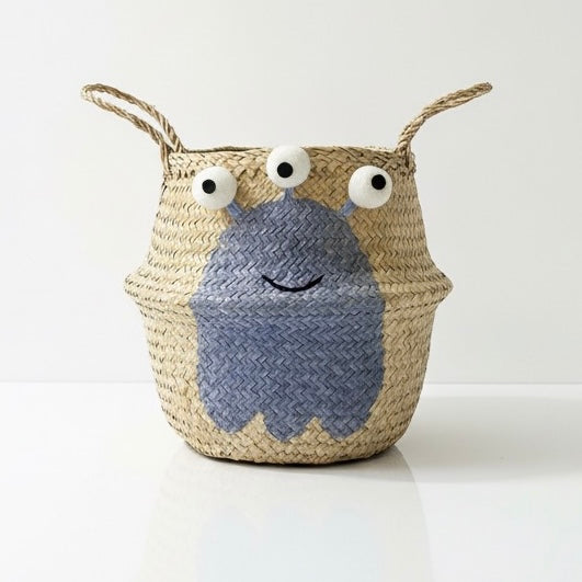 Blue Alien Basket, large: front view of woven basket with a blue alien, three googly eyes, smile and two top handles