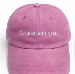 Pink cap with 'OVERSTIMULATED' text on a white background