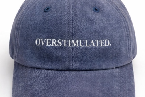 Blue cap with 'OVERSTIMULATED.' text on a white background