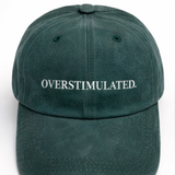 Green cap with 'OVERSTIMULATED' text on a white background