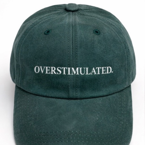 Green cap with 'OVERSTIMULATED' text on a white background