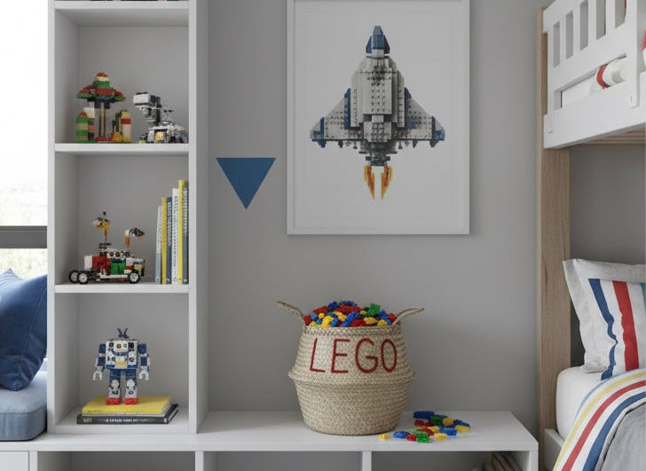 LEGO belly basket, large, filled with toy bricks on a low white shelf unit in a child's bedroom with a spaceship print