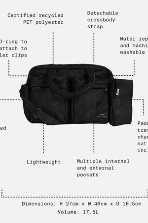Black duffel bag shown on a light gray background with dotted callouts and text describing features such as detachable crossbody strap, water repellent and machine washable fabric, padded travel changing mat, dimensions, and internal pockets.